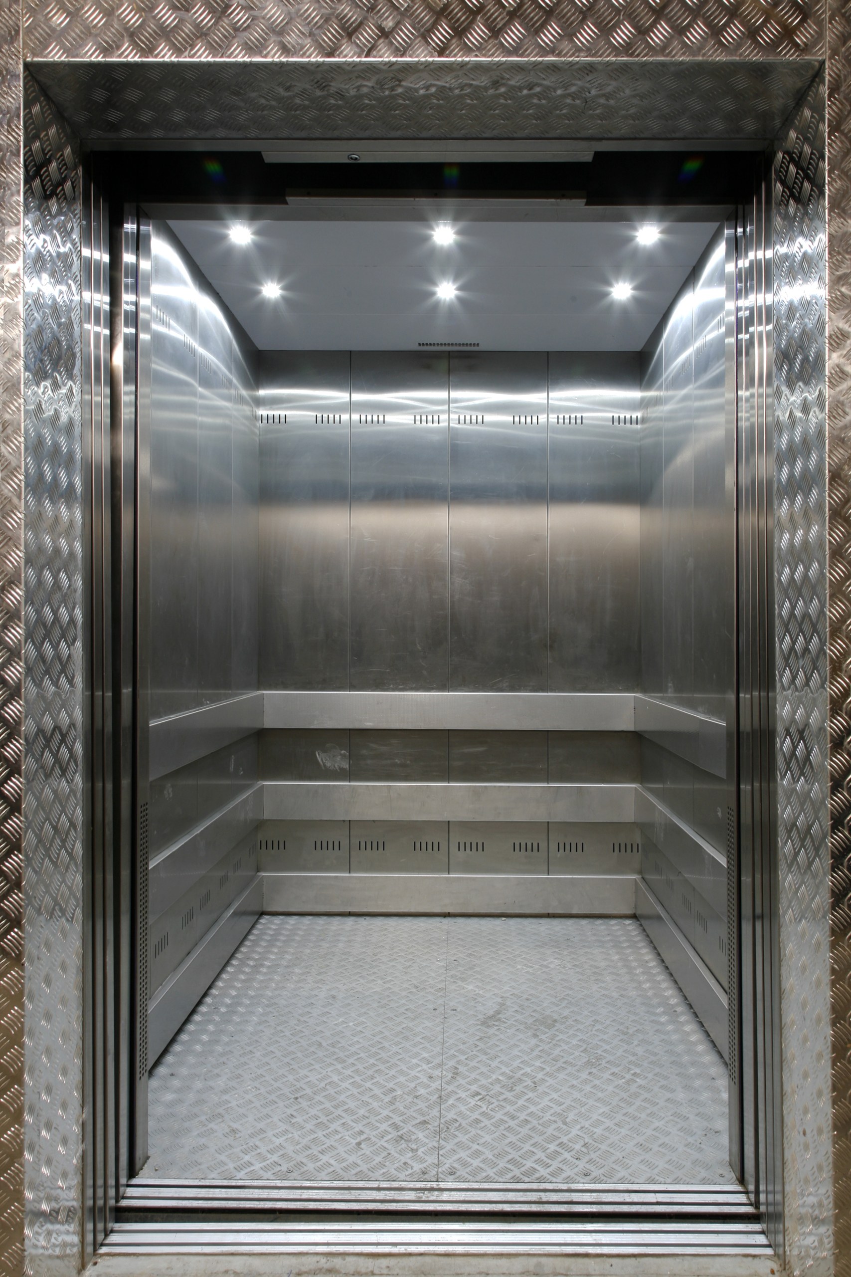 Open goods-lift cabin with stainless-steel Goods lift landing doors at a commercial building