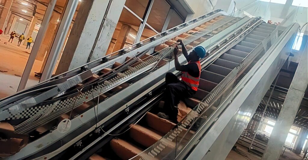 Installation team working on the paired escalators at the Paarl mall.