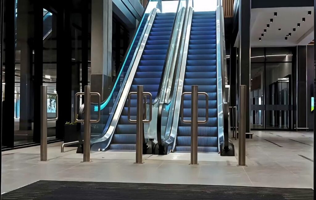 Completed paired escalators viewed from the lower landing.