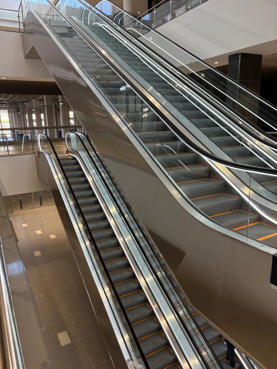 Glass-sided escalators connecting several floors around an open atrium.